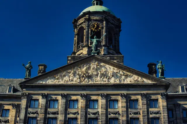 The clock-towered façade of the Royal Palace on Dam Square