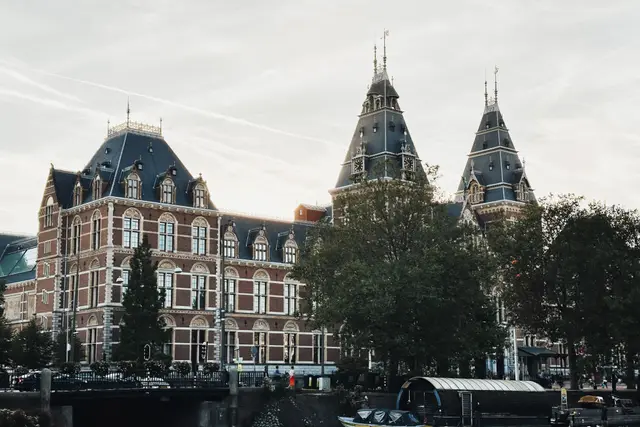 The Rijksmuseum building seen from a canal