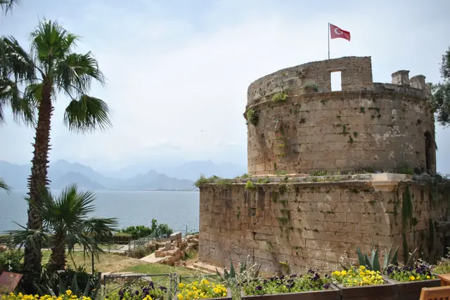 The round Hıdırlık Tower among palm trees