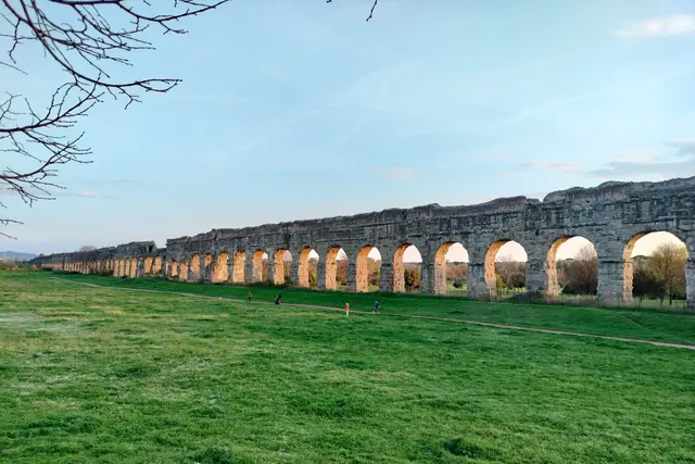 The Aspendos aqueduct arches running across a meadow