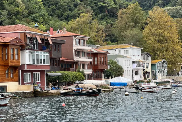 Colourful wooden houses on the Bosphorus shore and fishing boats at the quay