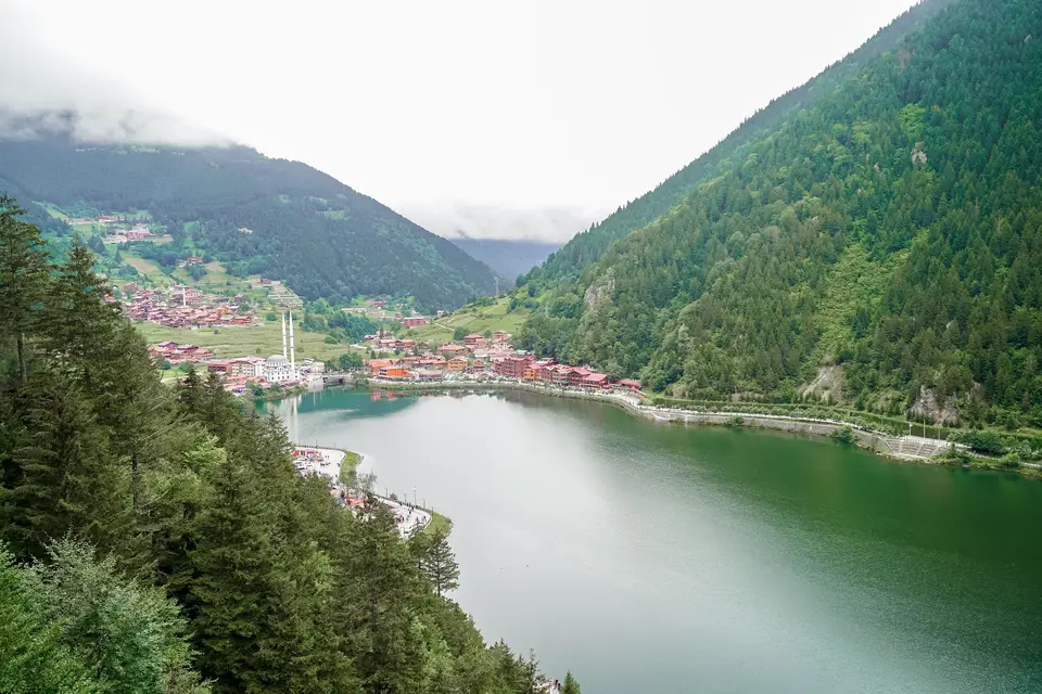 An aerial view of Uzungöl among forested mountains